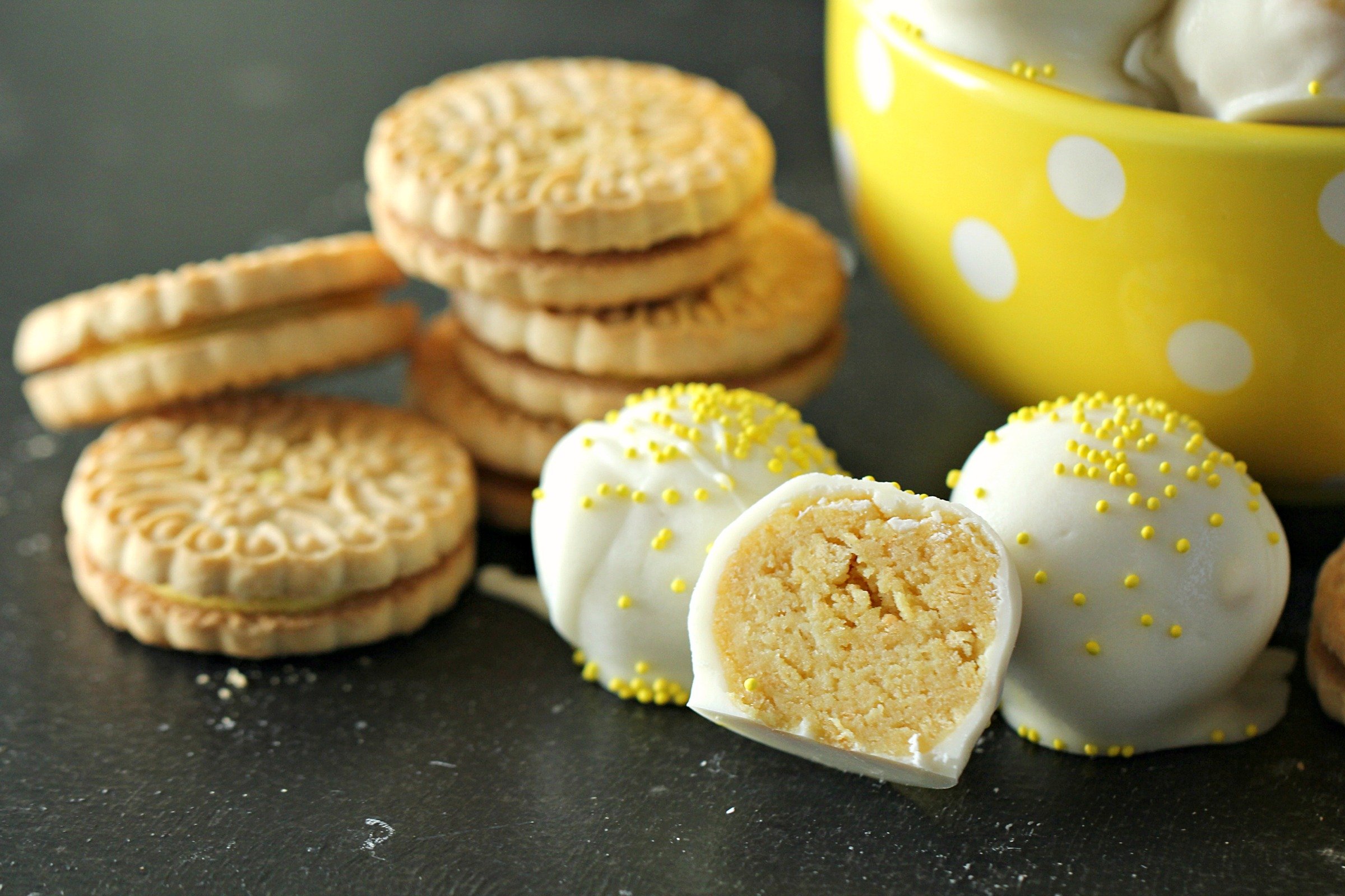 No Bake Lemon Cookie Truffles with one cut in half to show the inside