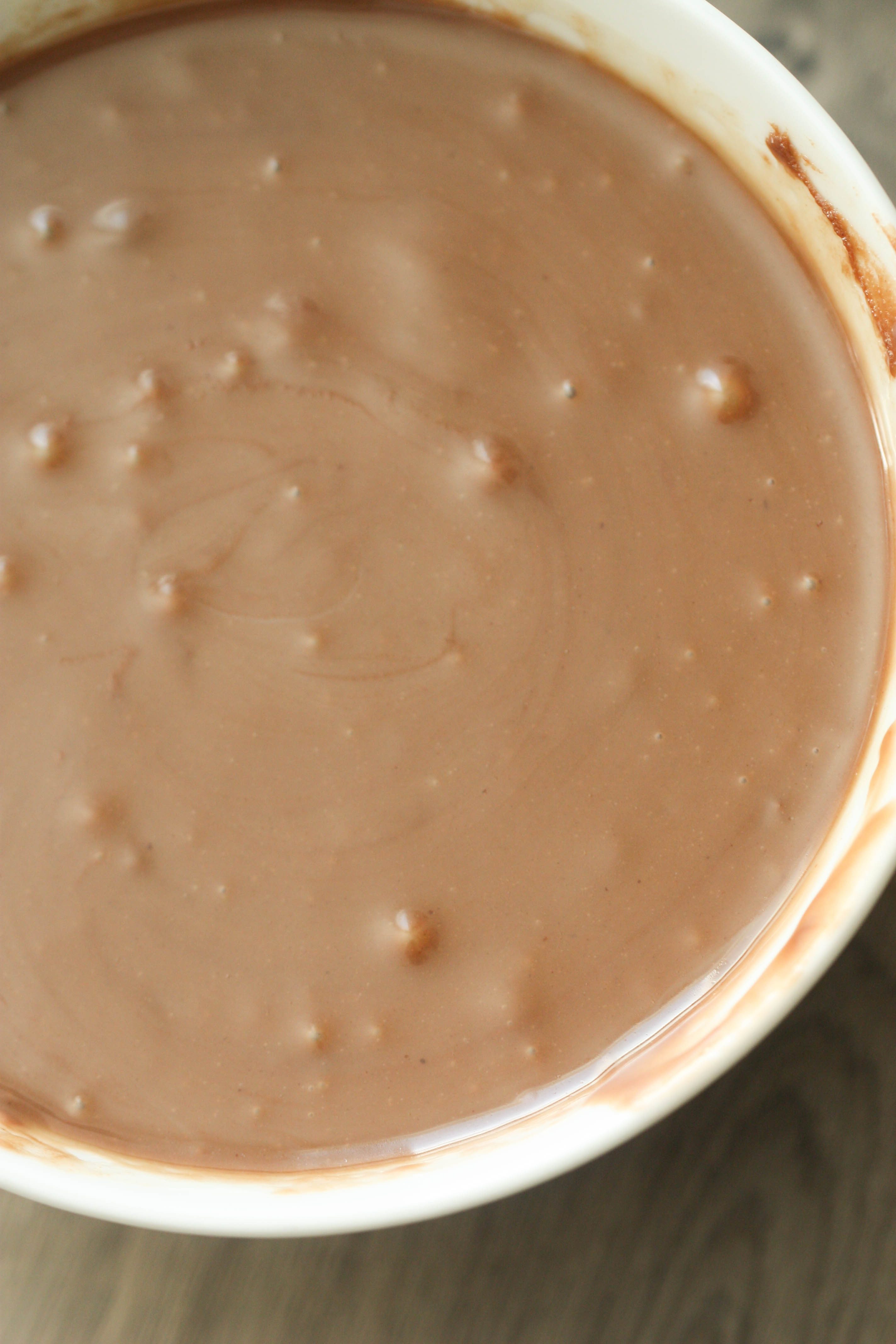 Sweetened condensed milk and chocolate peanut butter mixture mixed in a white bowl
