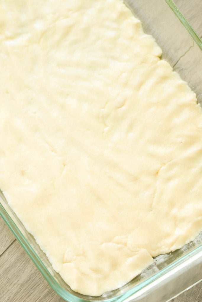 Cake Mix Cookie Bar dough in a baking dish.