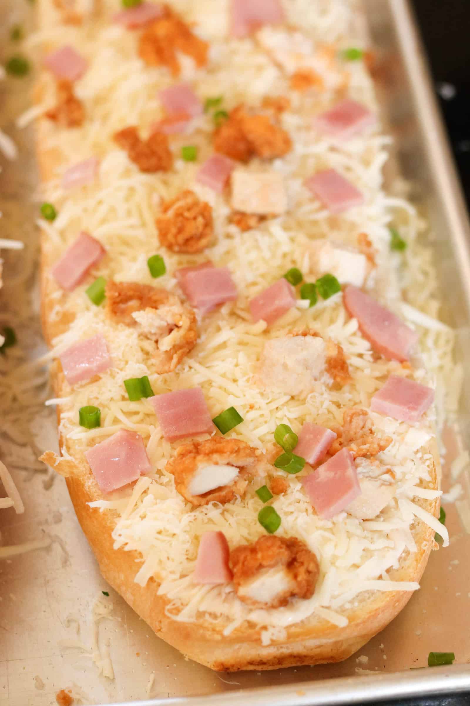 Chicken Cordon Bleu French Bread Pizza baked on a sheet pan