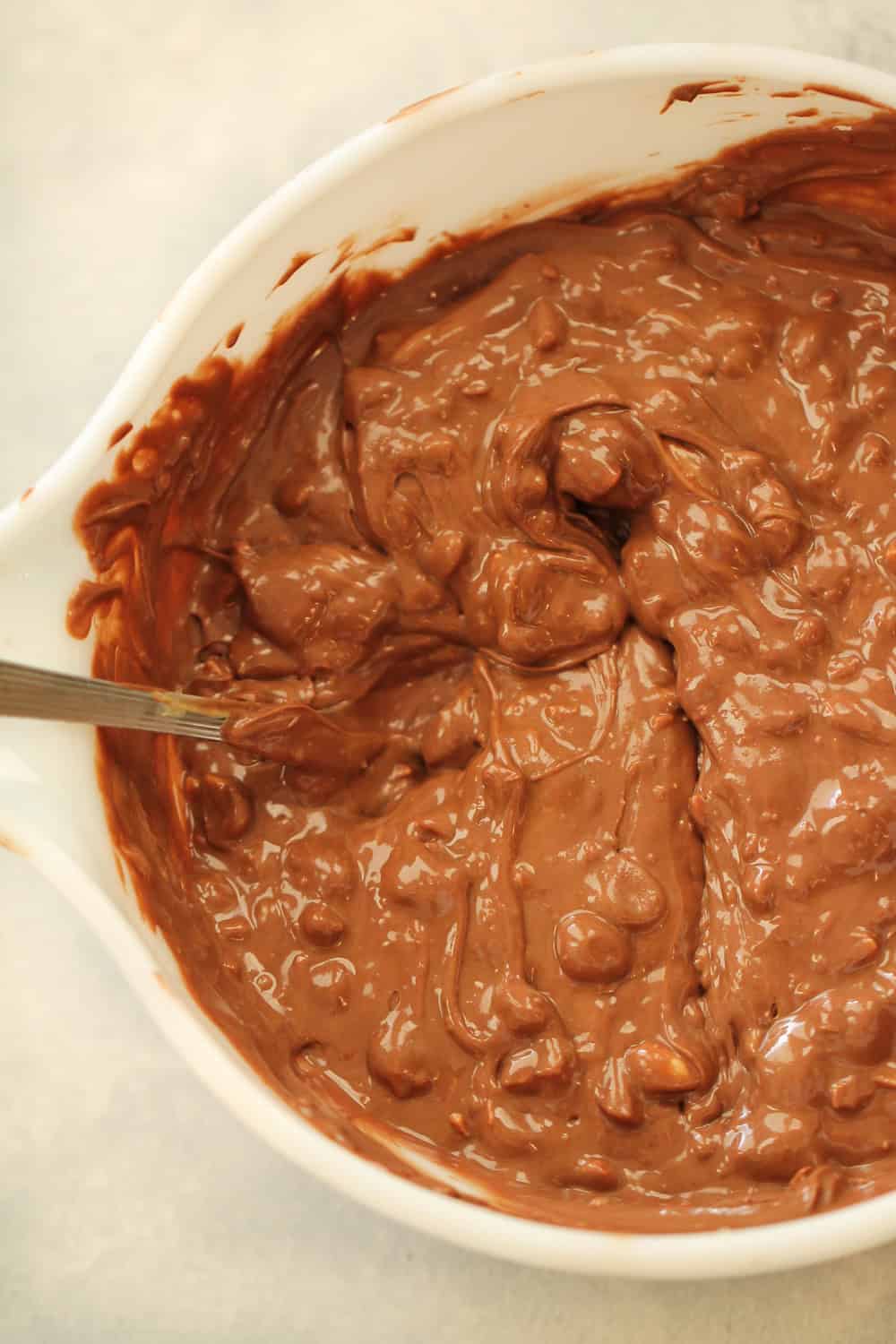 chocolate and peanut layer melted in a bowl and ready to go on top of the cherry layer