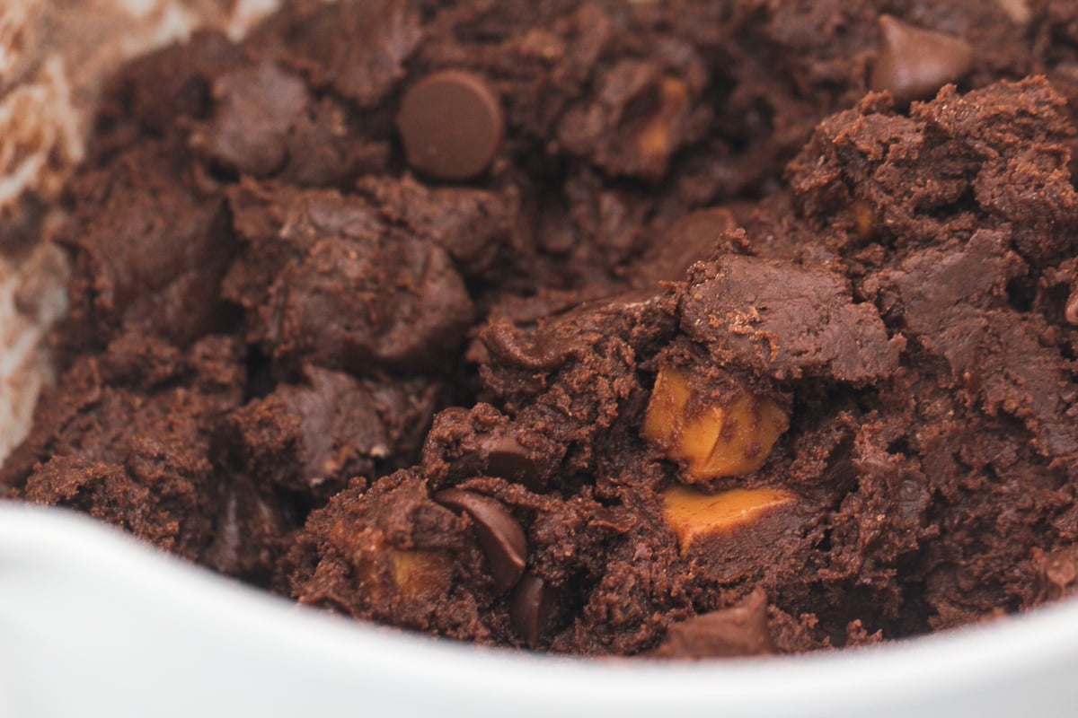 A mixing bowl of Chocolate Caramel Nutella Cookies dough