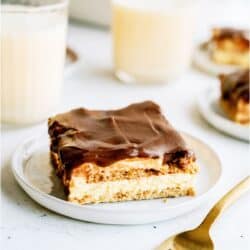A slice of Eggnog Eclair Cake on a plate with a fork.