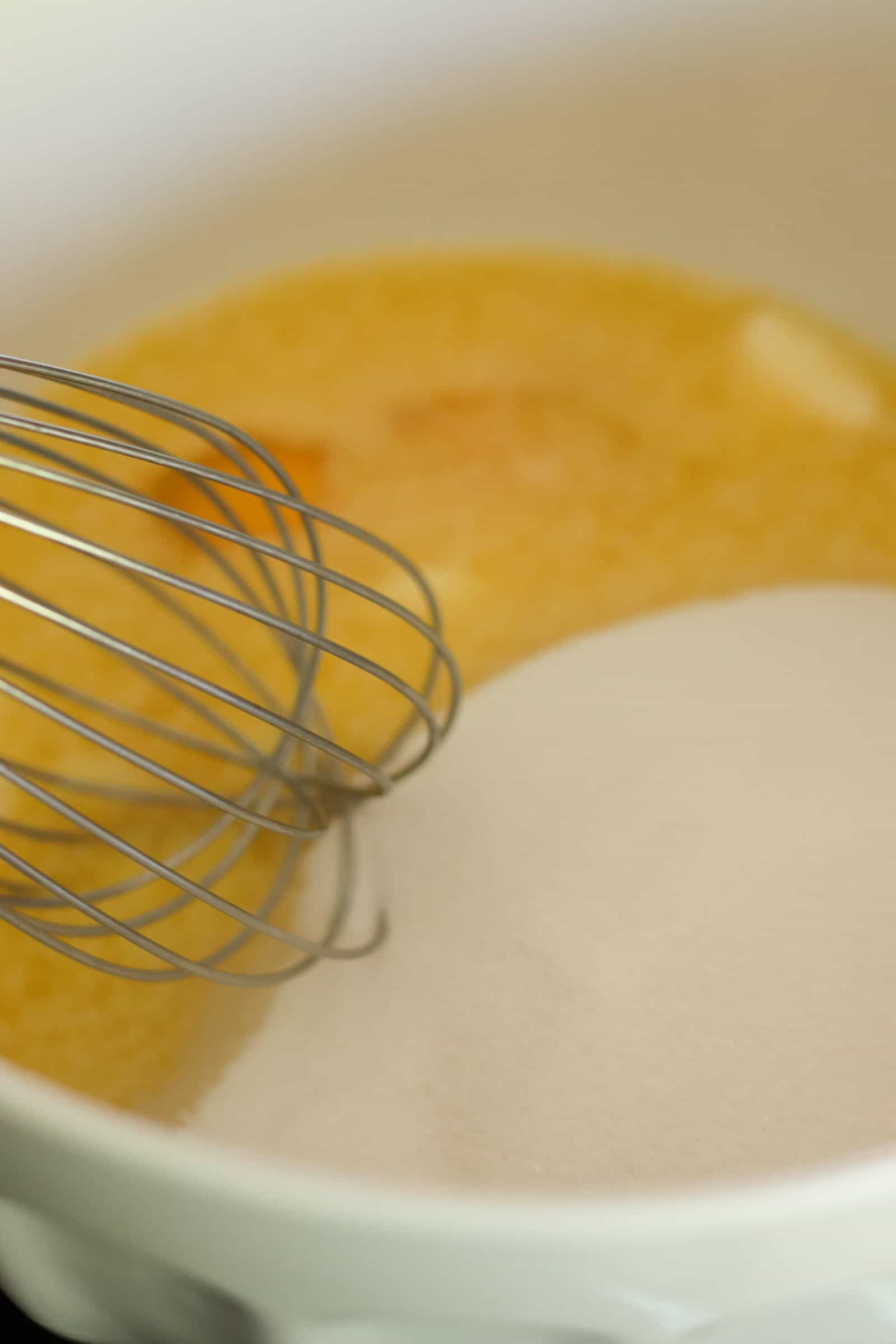 Eggs, sugar and butter in a mixing bowl