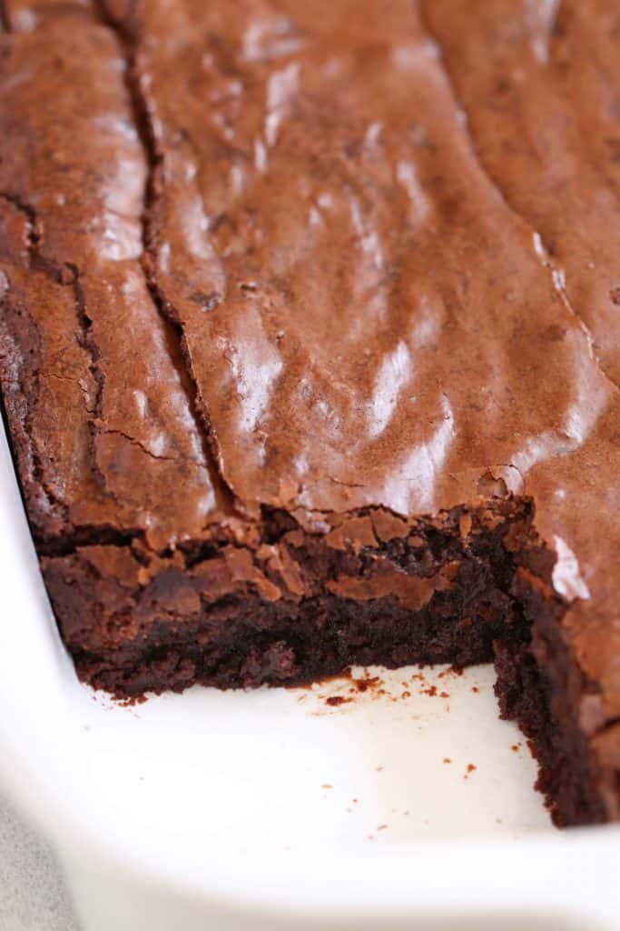 Fudgy Nutella Brownies in baking dish with the corner piece missing.
