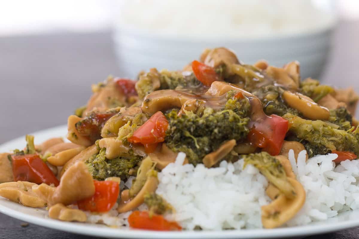 Instant Pot Cashew Chicken served over rice on a plate