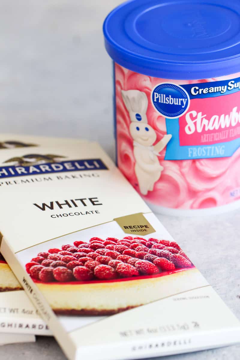 white chocolate bark and strawberry frosting in separate containers