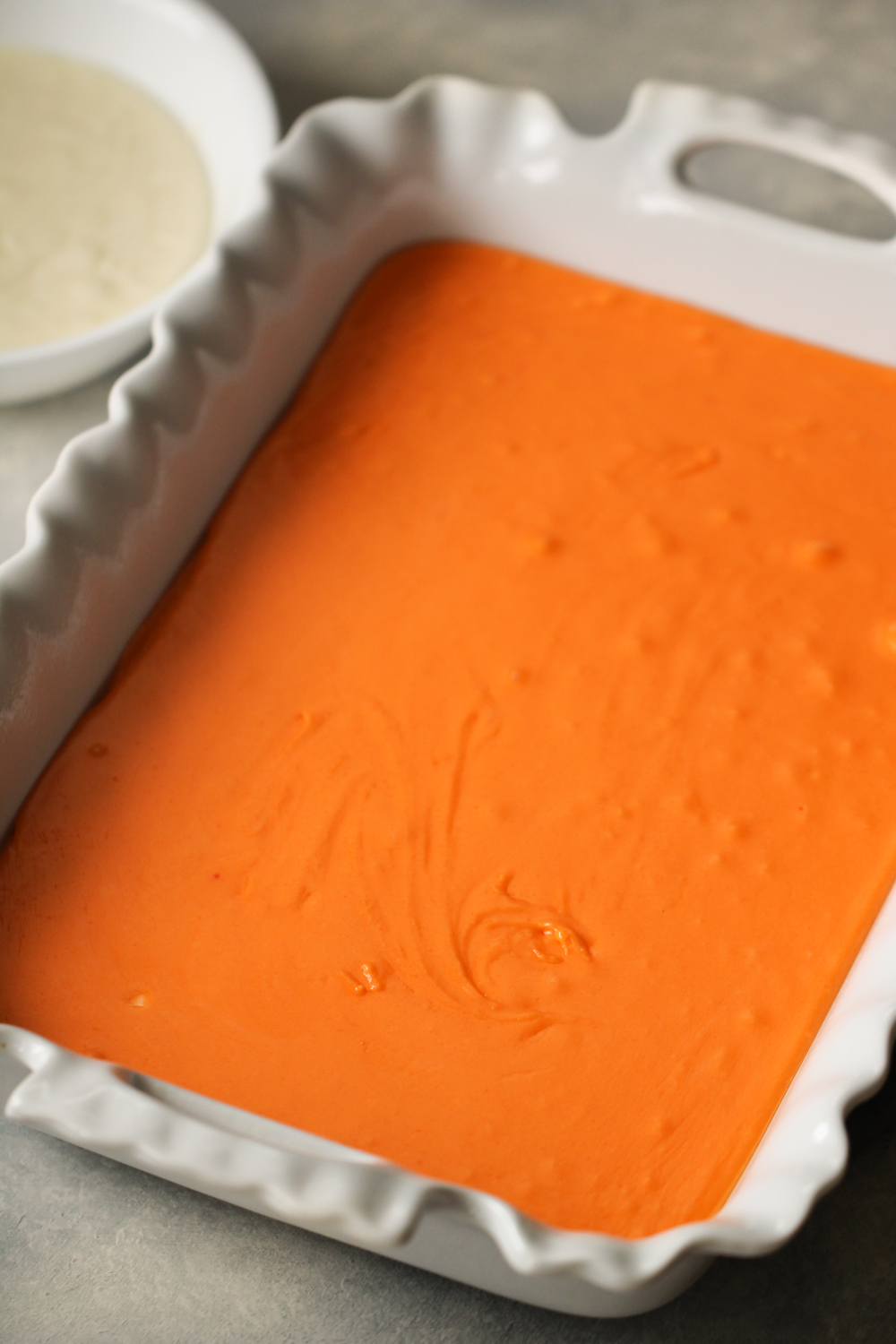 Orange layer of fudge place in the pan.