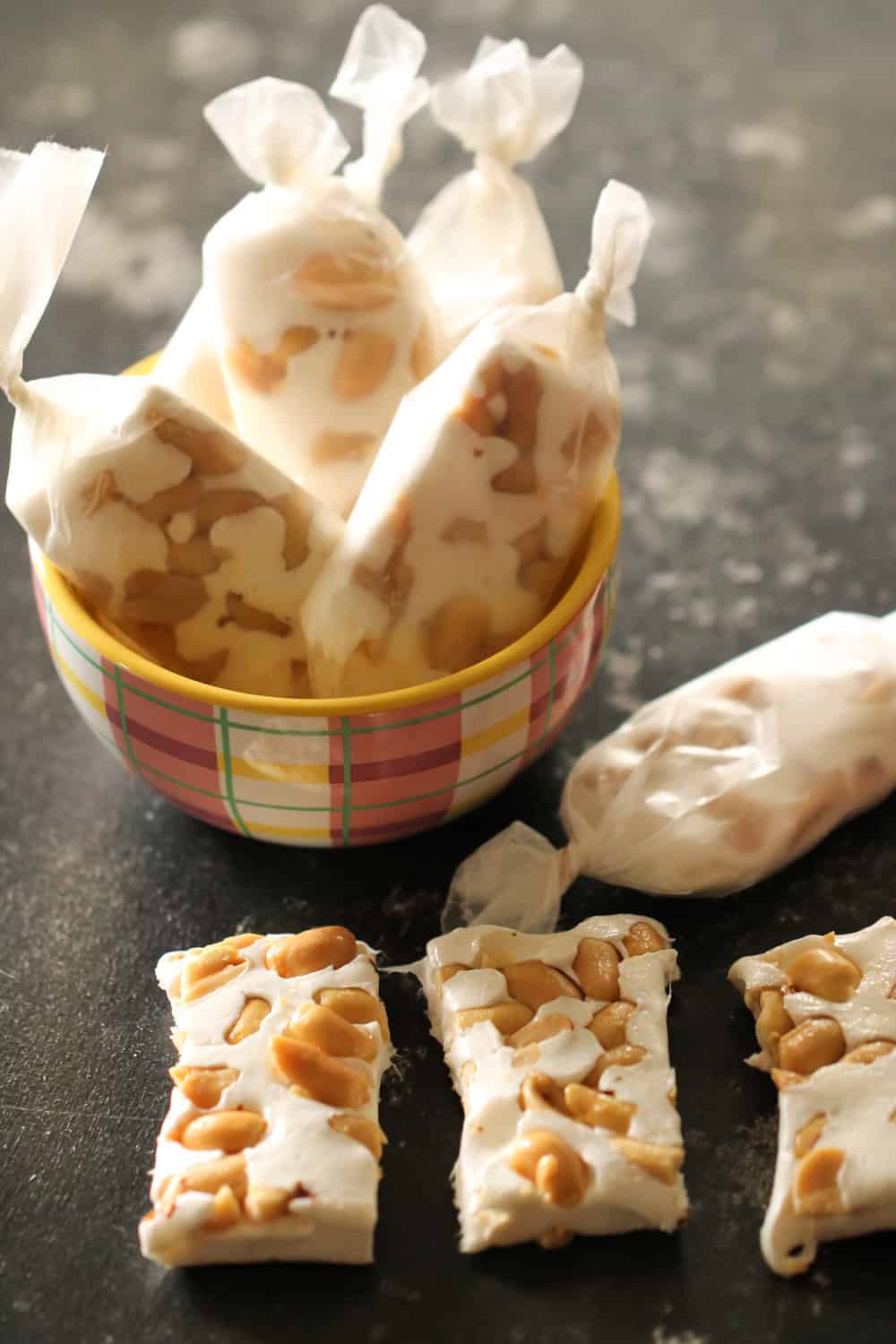 Homemade Big Hunk Candy Bars cut into squares with some wrapped in wax paper