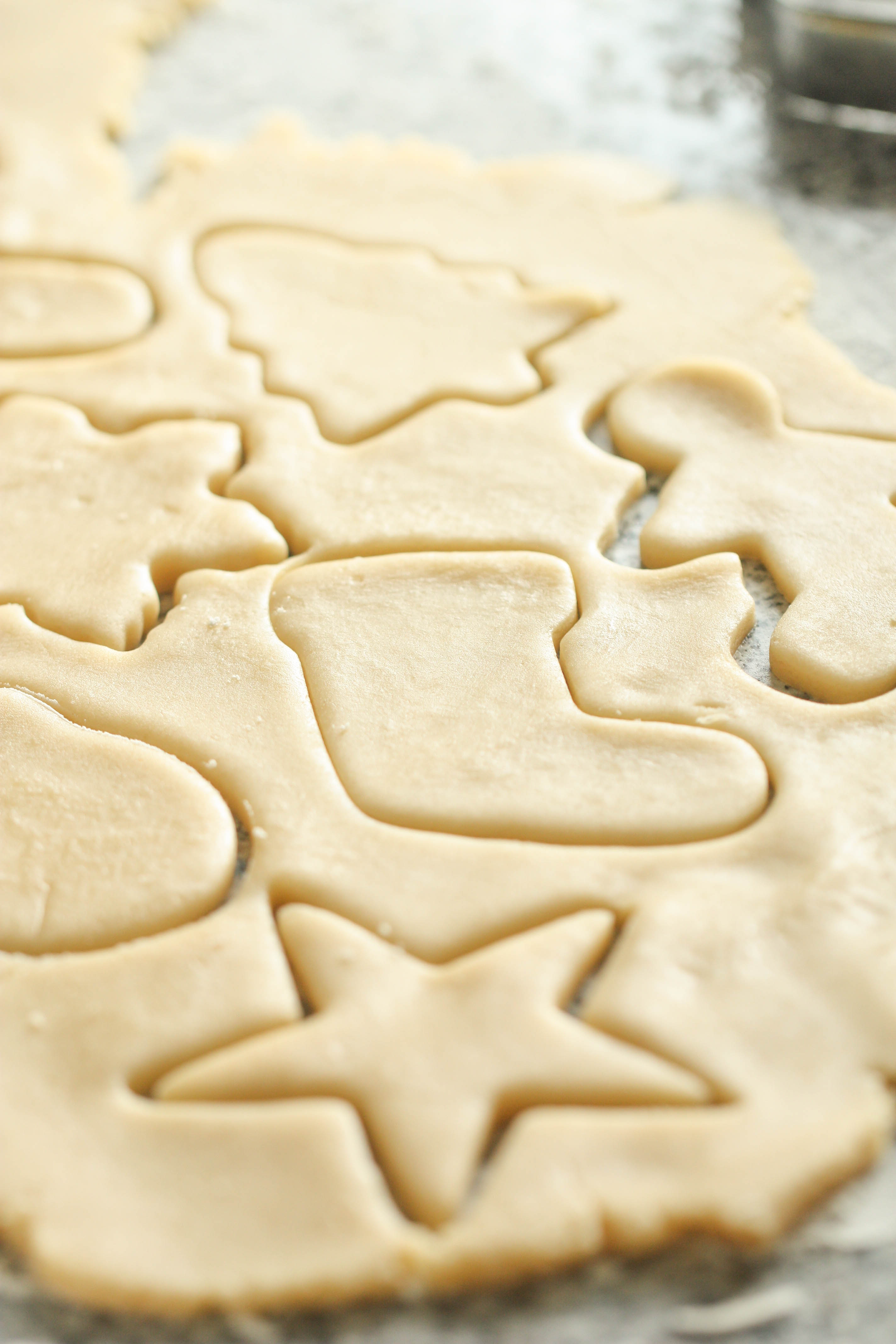 Sugar cookie dough with cutout shapes
