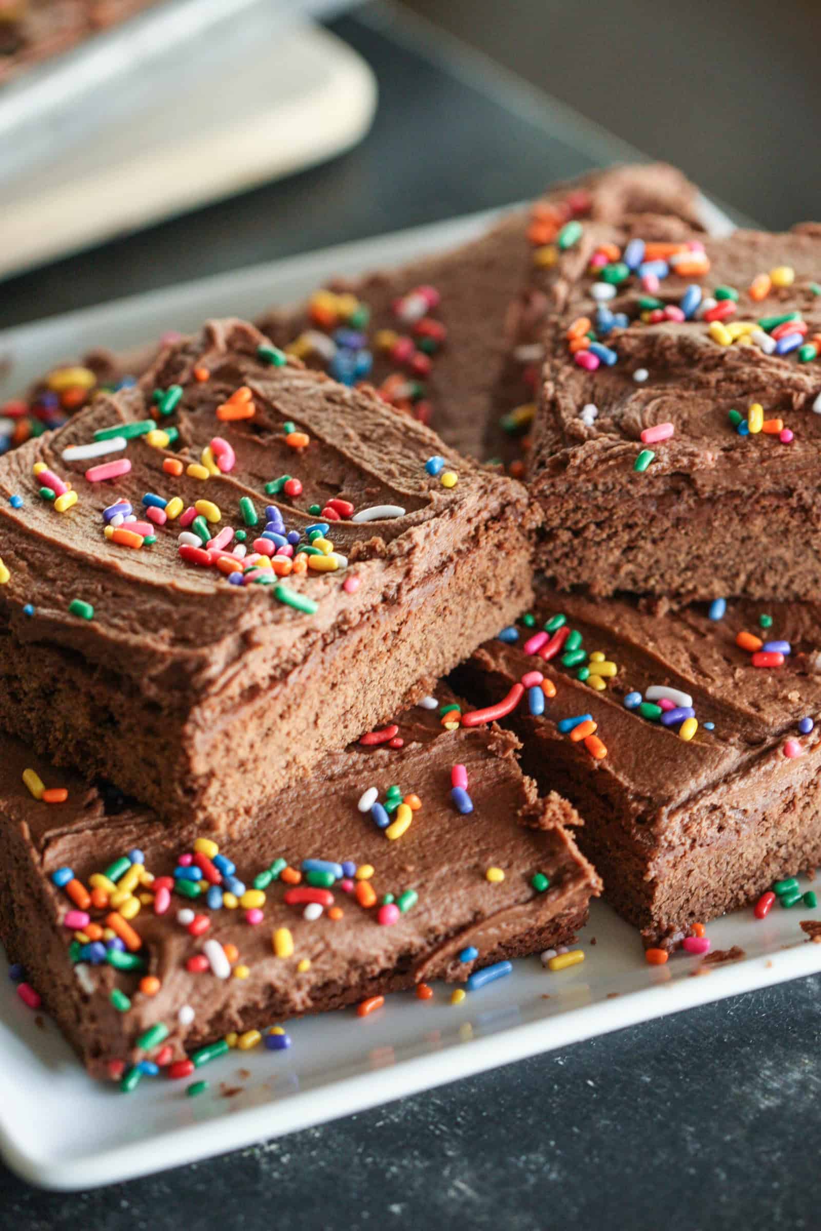 Chocolate Sugar Cookie Bars
 on a white plate with sprinkles on top