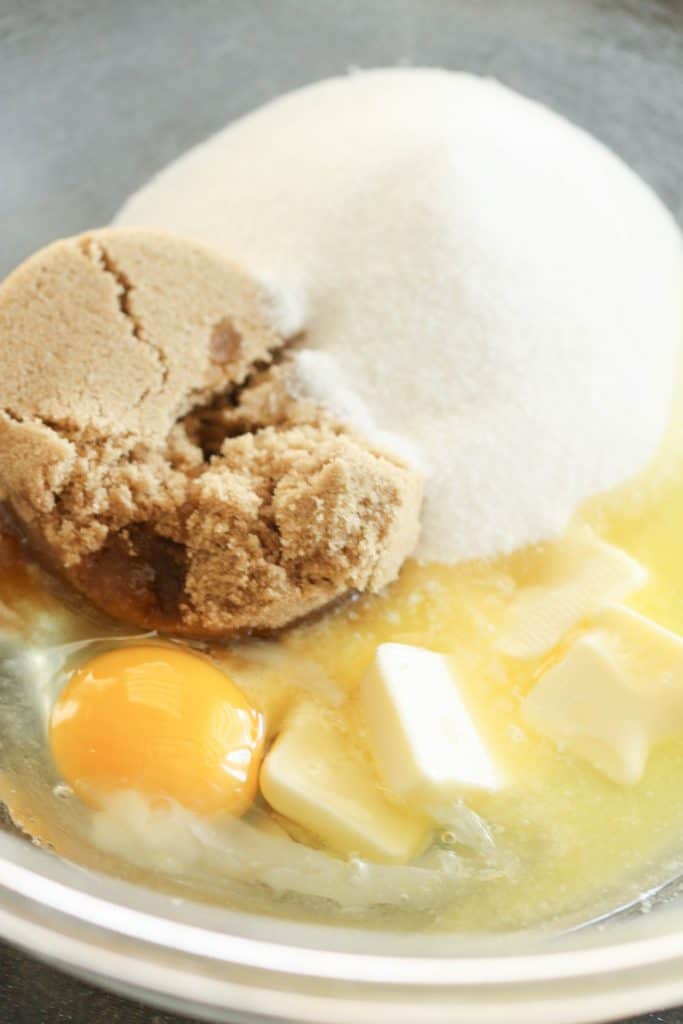 A bowl of sugar, butter and eggs.