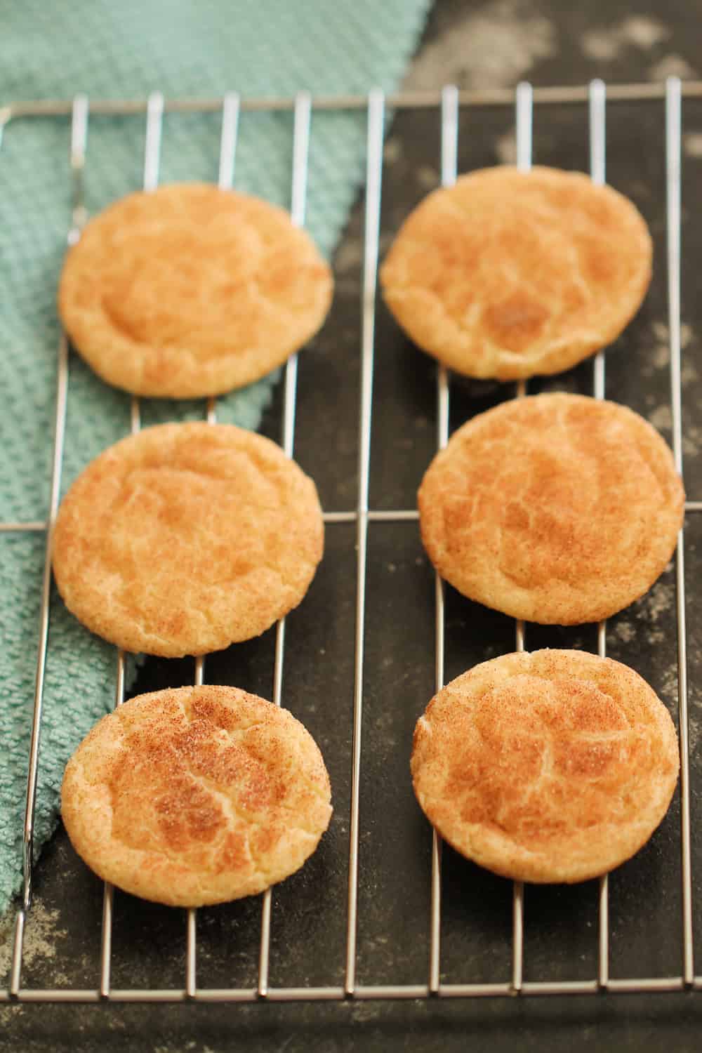 Baked Snickerdoodle cookies on cooling rack