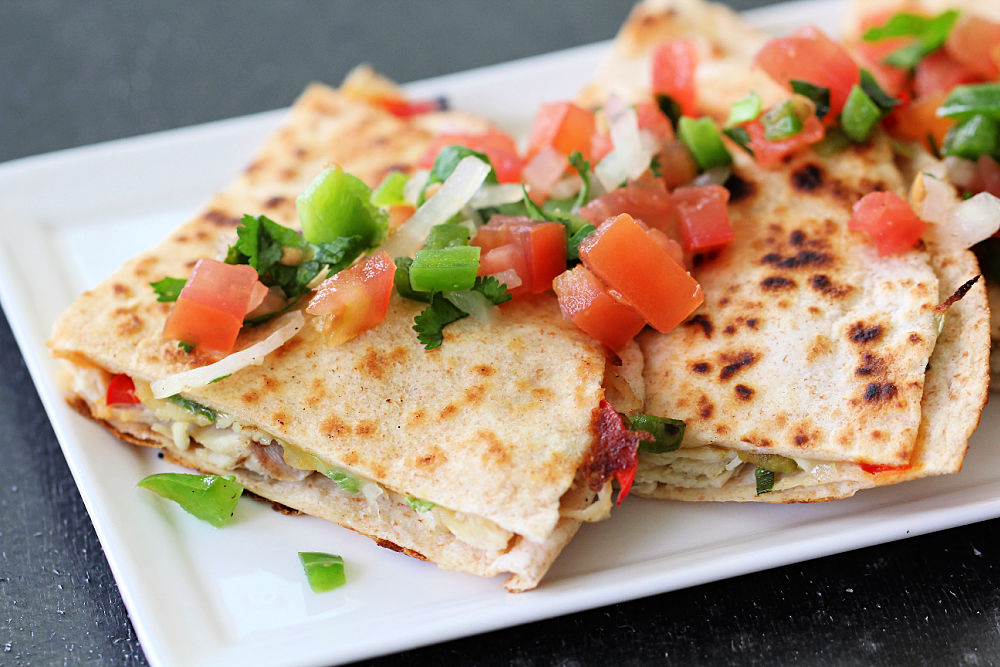 Green Chile and Chicken Quesadillas sliced on a serving plate