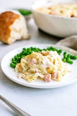 chicken cordon blue with potatoes and peas on a plate