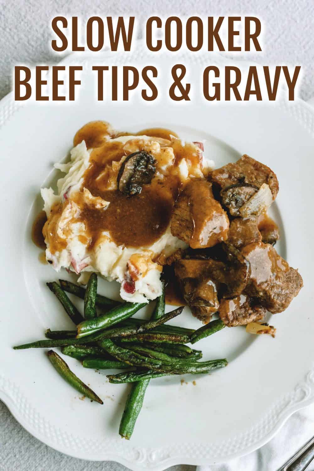 Slow Cooker Beef Sirloin Tips and Gravy served over mashed potatoes with green beans