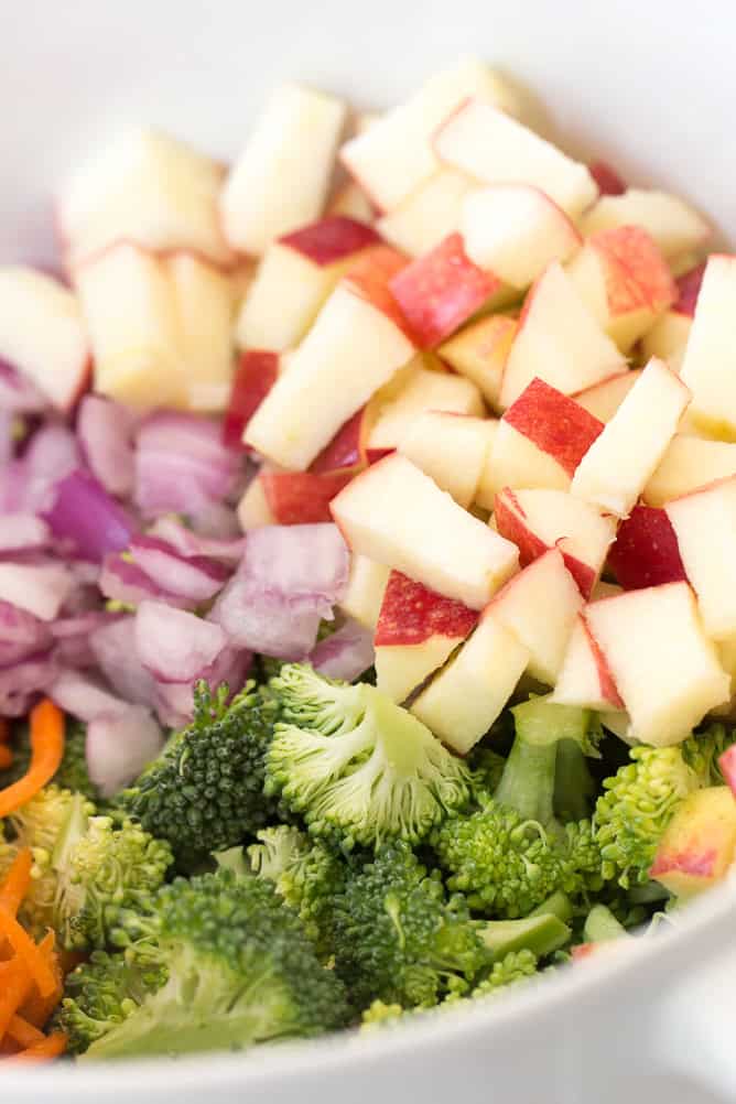 Ingredients for Broccoli Apple Salad chopped in a mixing bowl