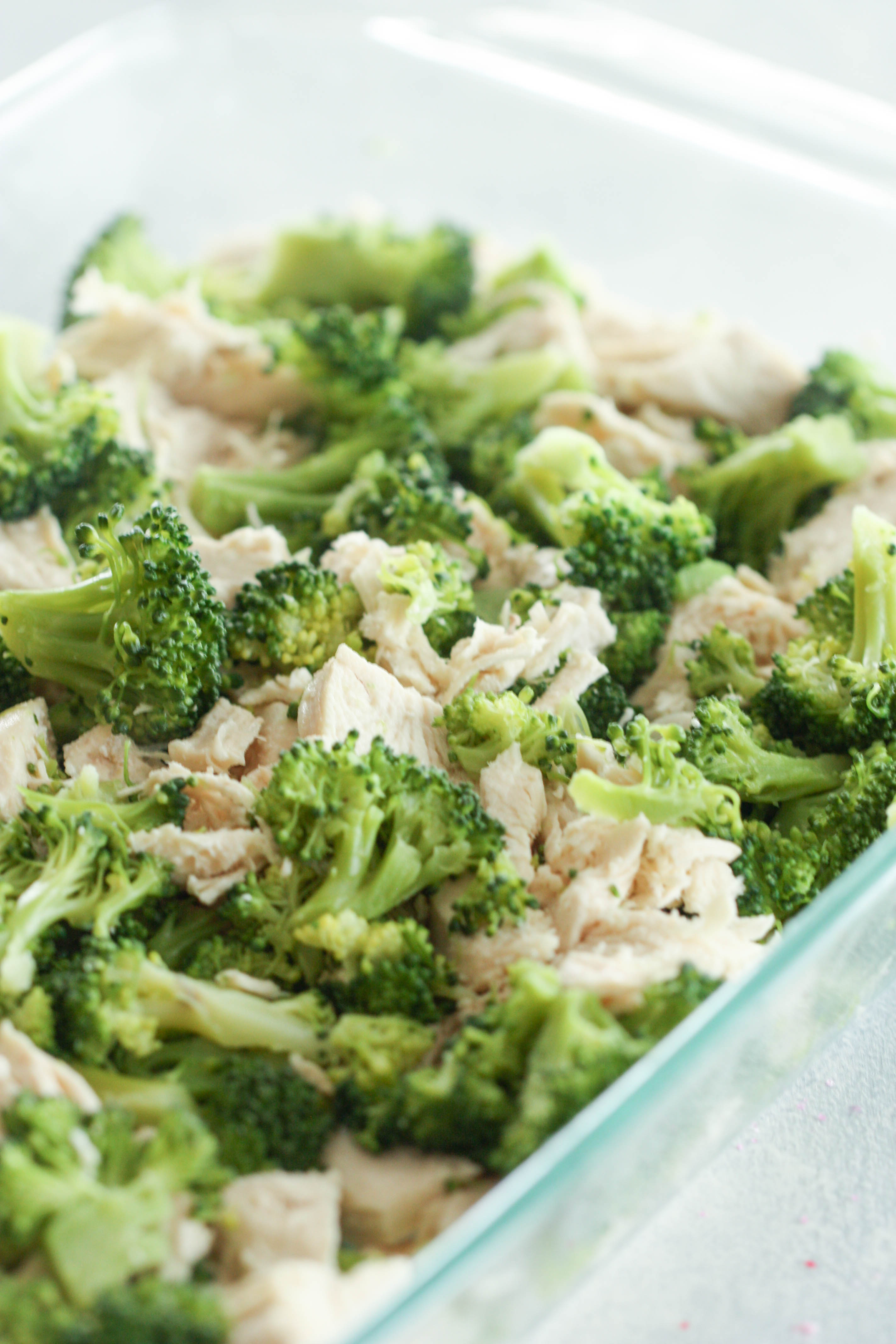 Chicken and broccoli tossed together in casserole dish