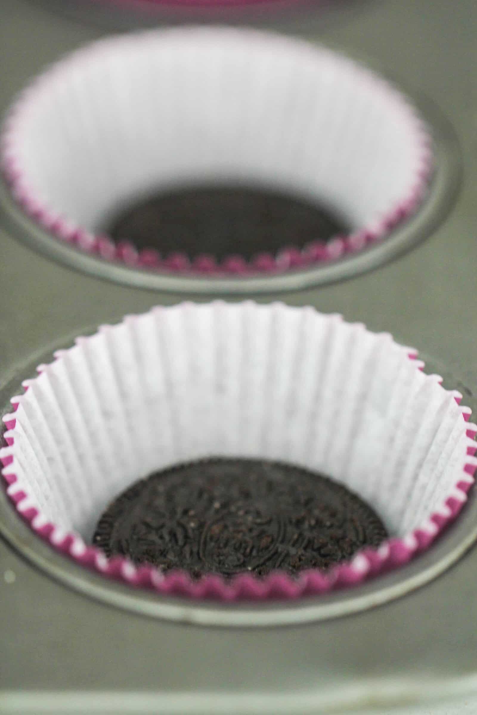 Oreo cookie in a cupcake wrapper inside a muffin tin