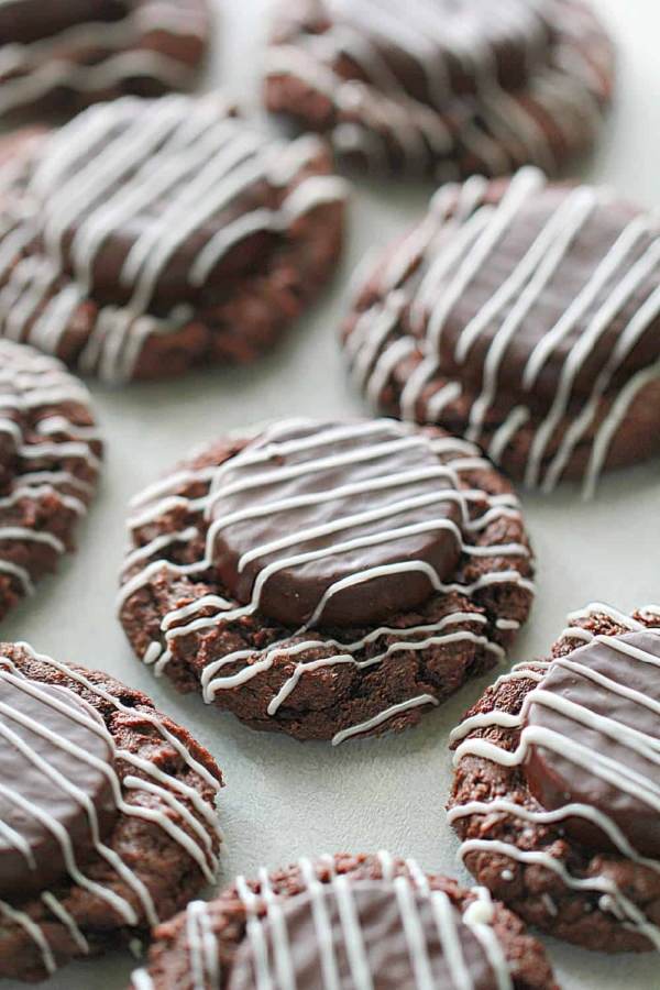 chocolate thumbprint mint cookies with icing drizzeled