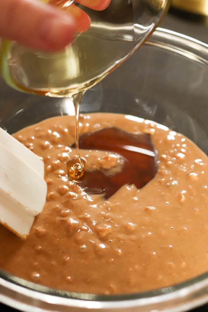 Adding honey to the melted peanut butter mixture.