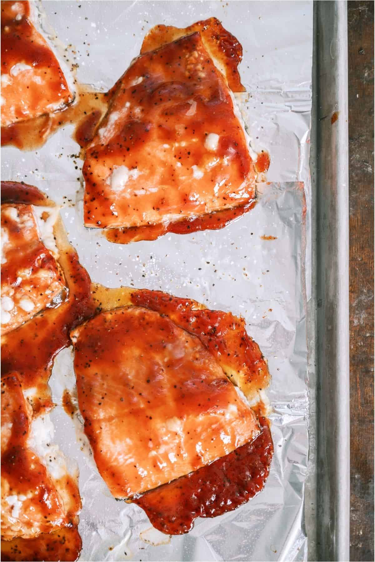 BBQ Baked Salmon on a lined shett pan.