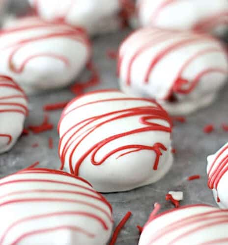 White chocolate covered Red Velvet Cake Bites lined up in rows.