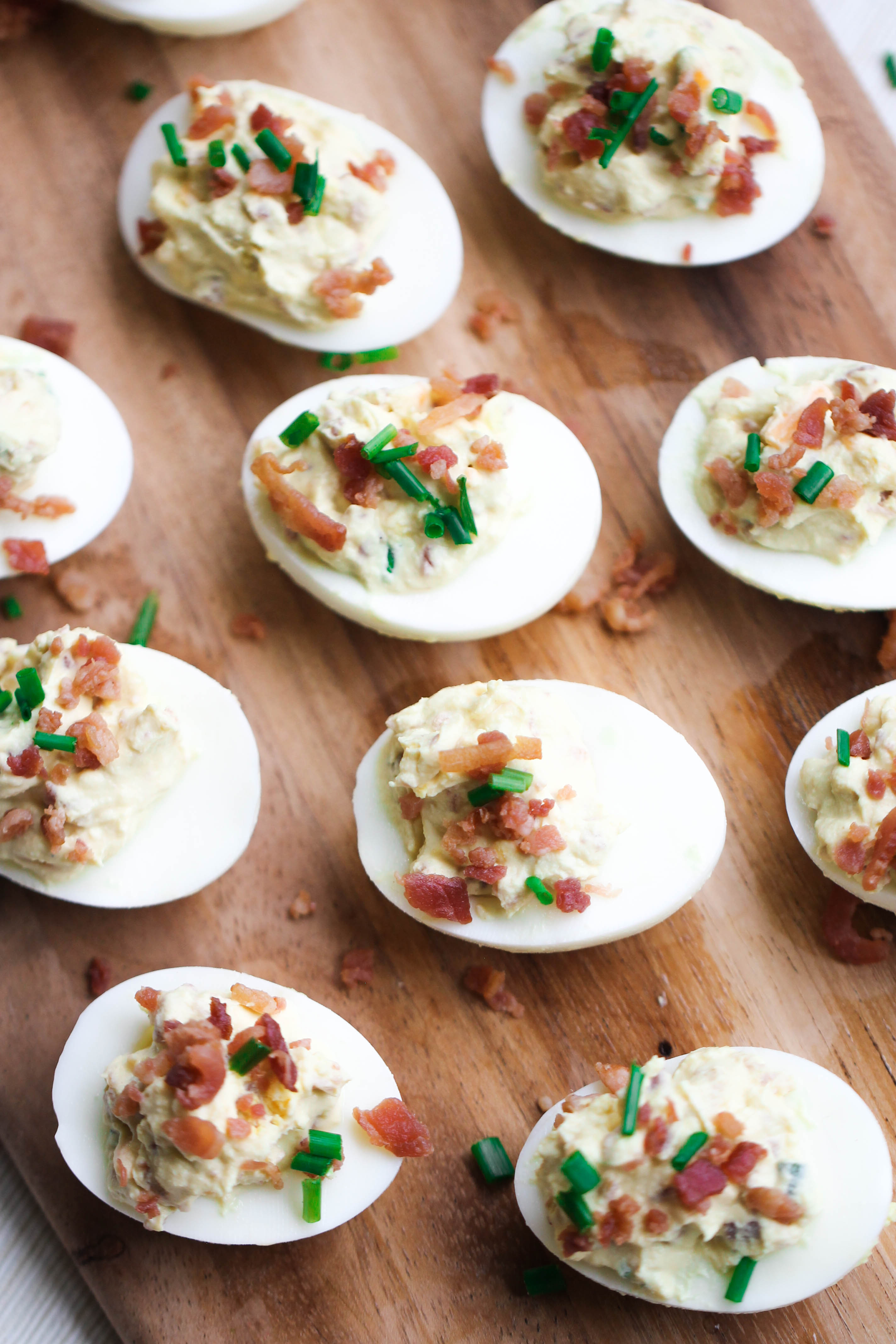 Loaded deviled eggs on a cutting board