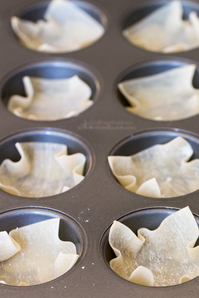 Wonton wrappers in a muffin tin