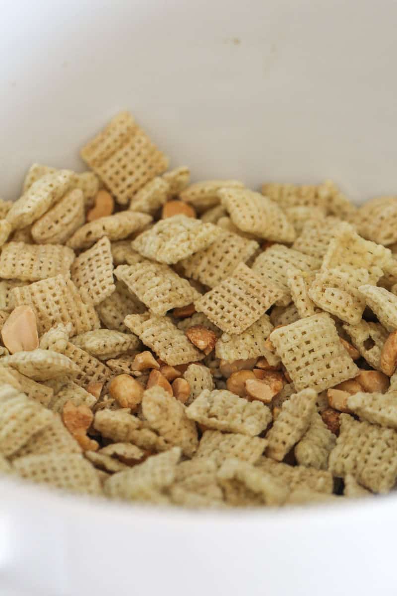 peanuts and rice chex mixed in a bowl