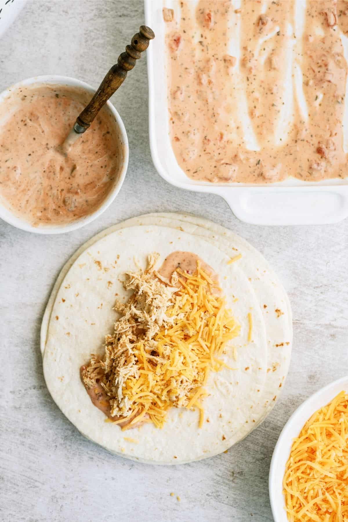 Flour tortilla with shredded chicken and ranch salsa mixture topped with cheese