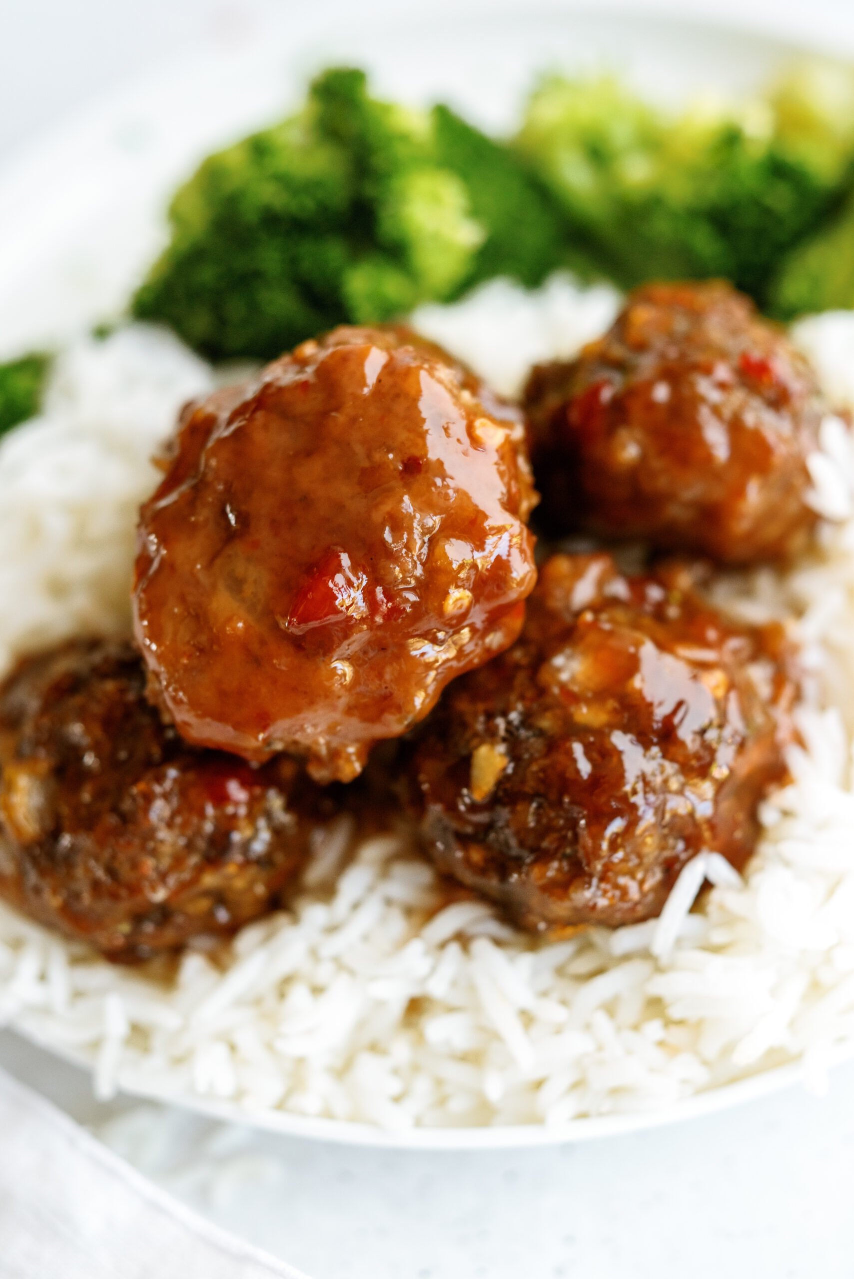 Sweet Polynesian Meatballs on a plate of white rice