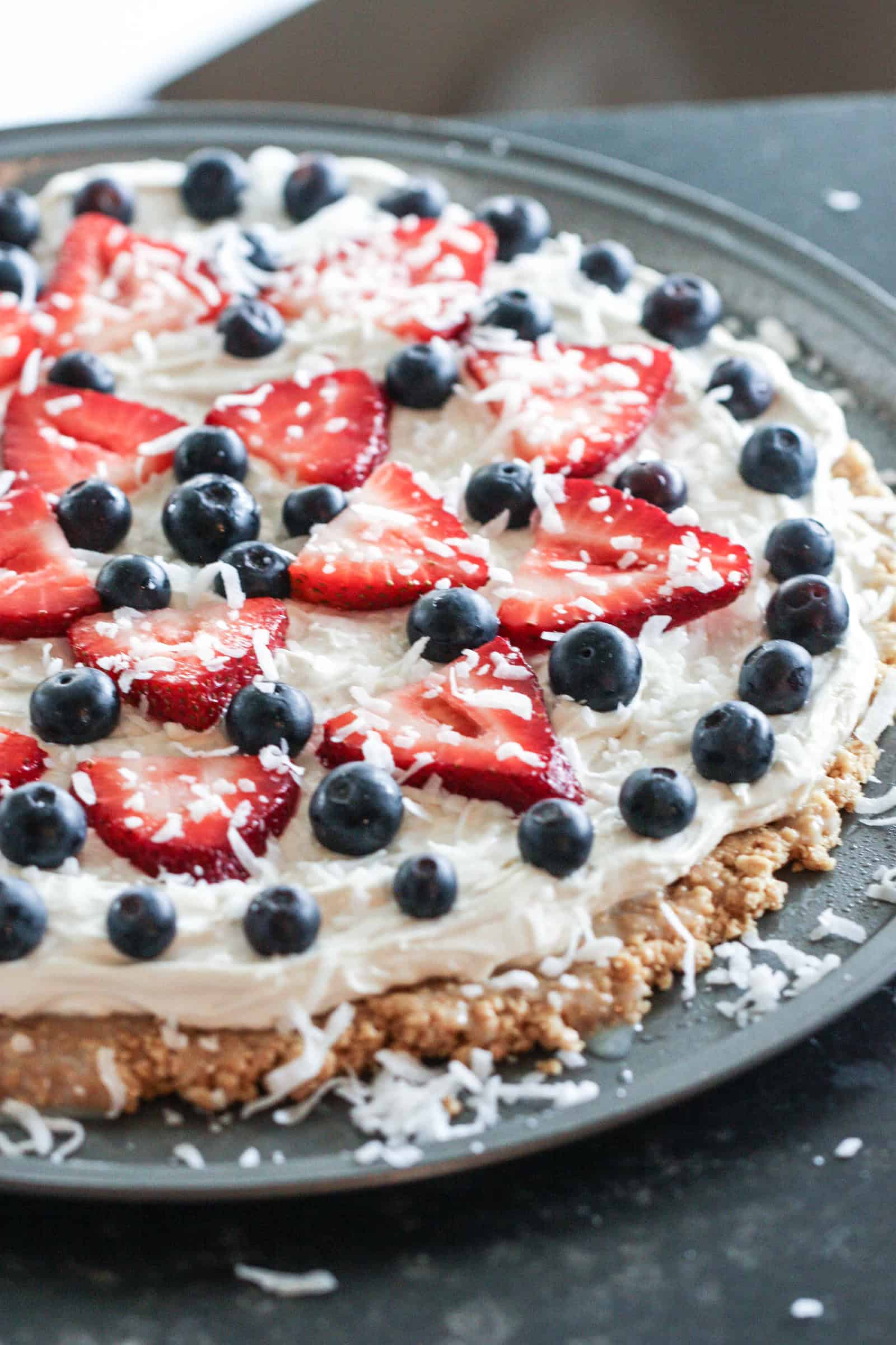 Patriotic Fruit Pizza on a round cookie sheet