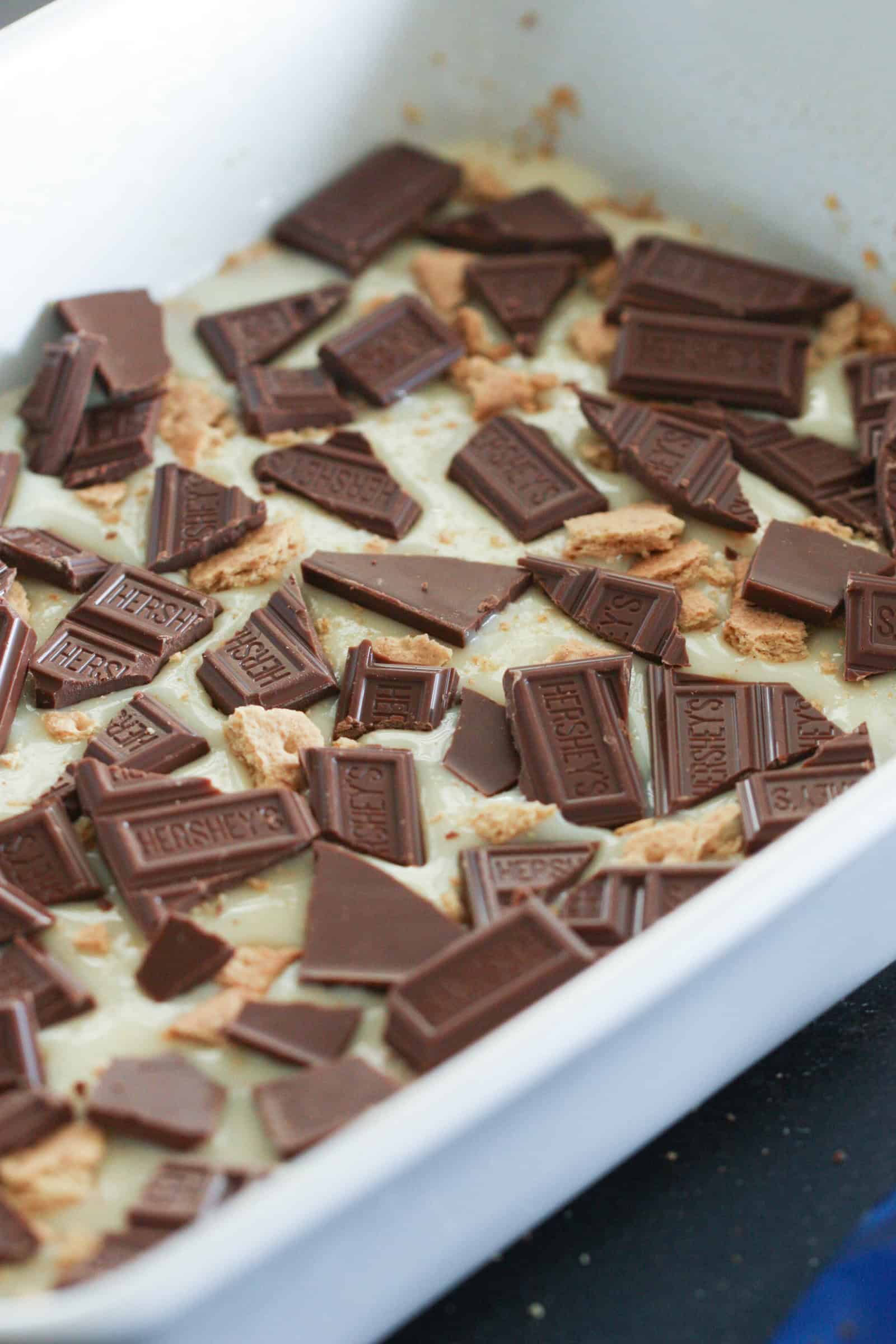 Marshmallow and Chocolate on top of graham cracker crust in pan