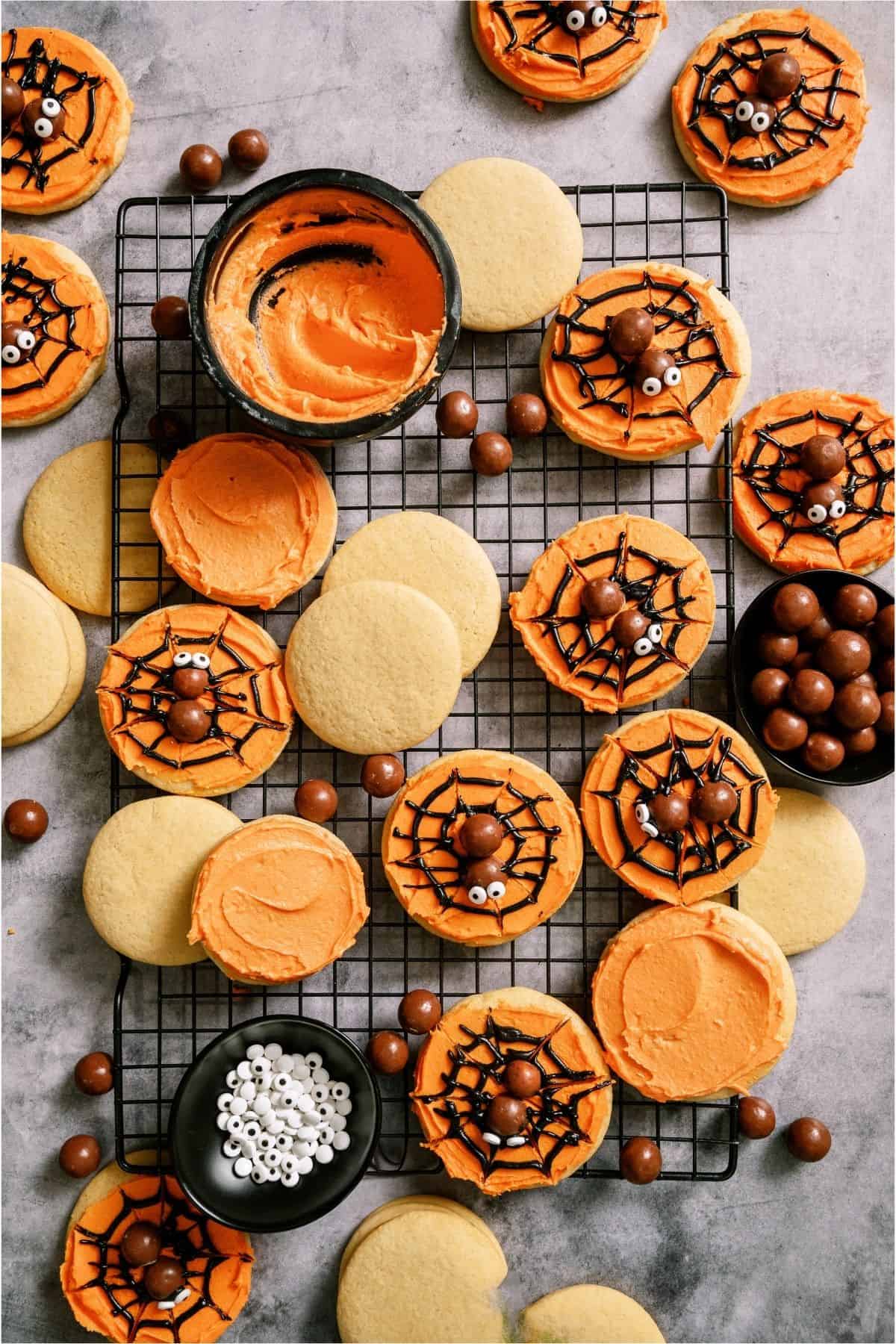 Spider web sugar cookies decorated with chocolate and white sprinkles for Halloween.