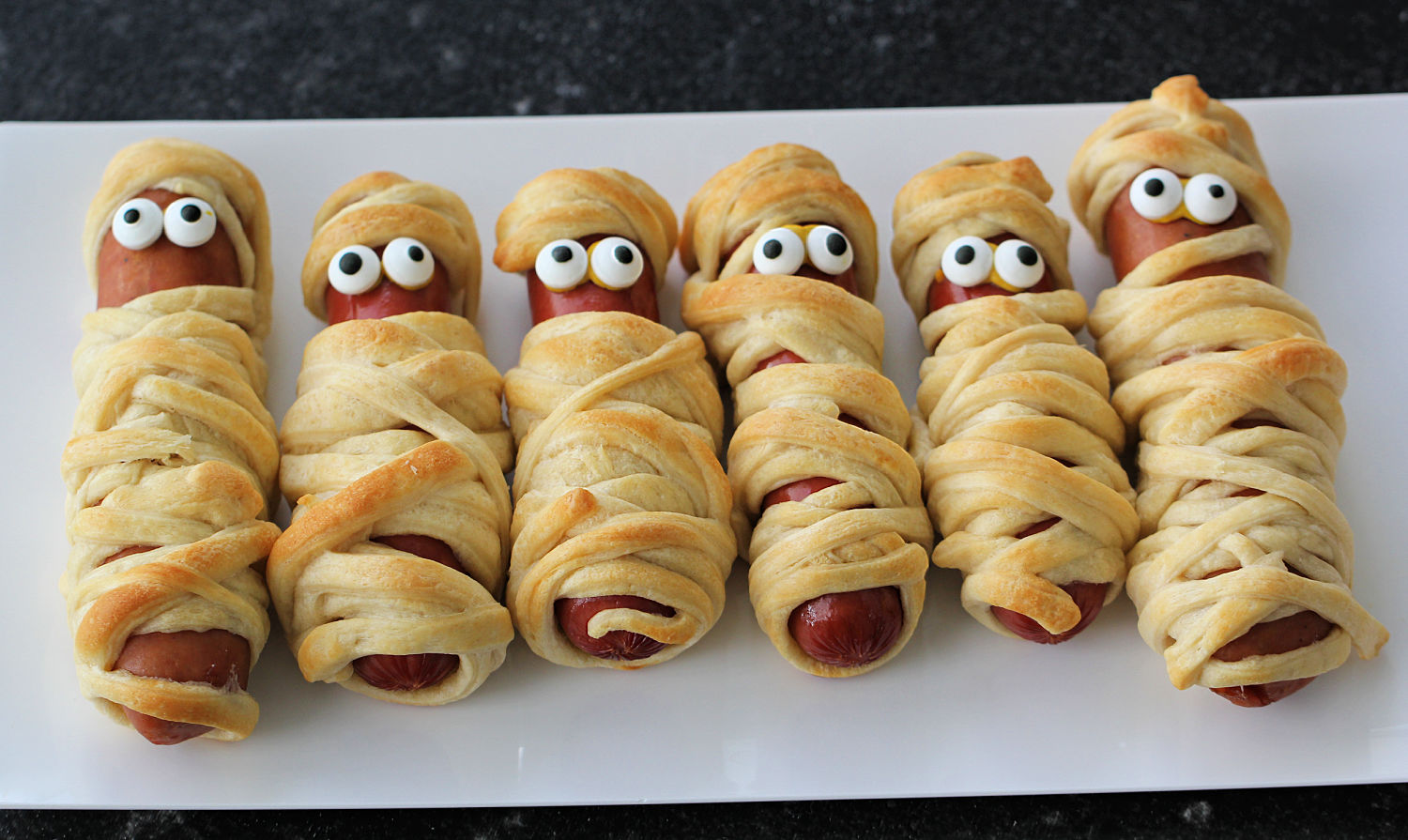 Our Halloween Mummy Dogs are the perfect dinner for Halloween!