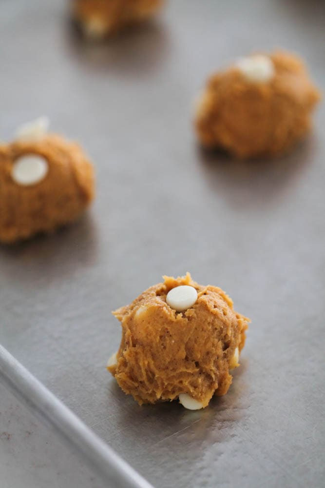 White Chocolate Cheesecake Pumpkin Cookie dough balls on a baking sheet