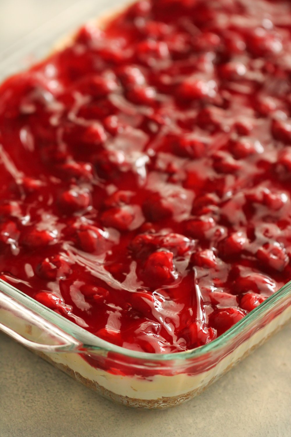 cherries spread on top of pudding layer in pan
