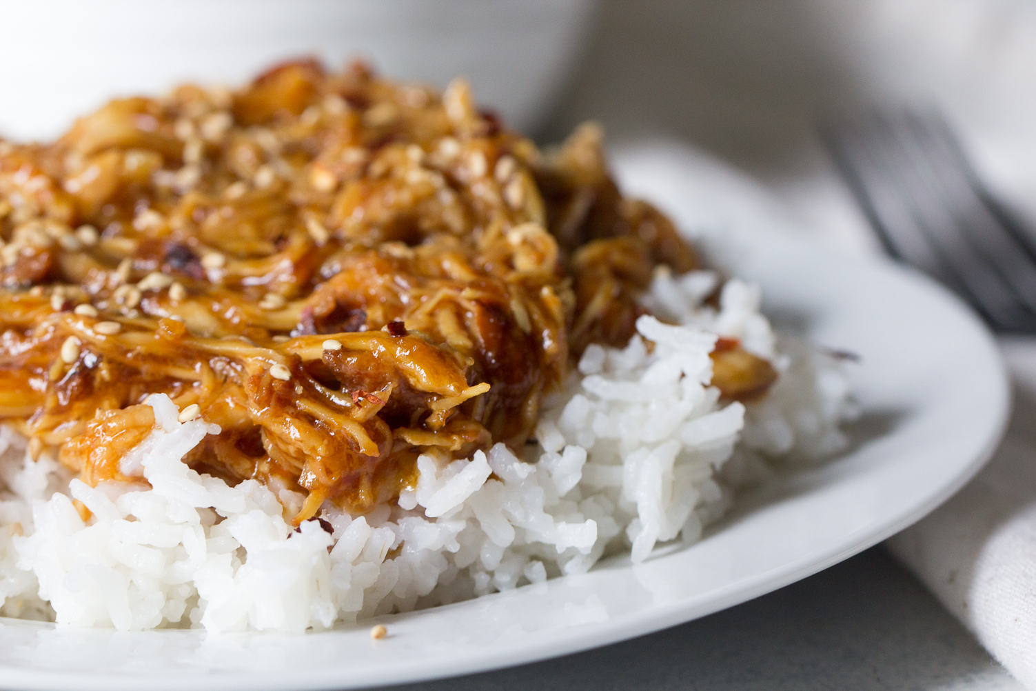 Instant Pot Honey Sesame Chicken served over rice on a plate