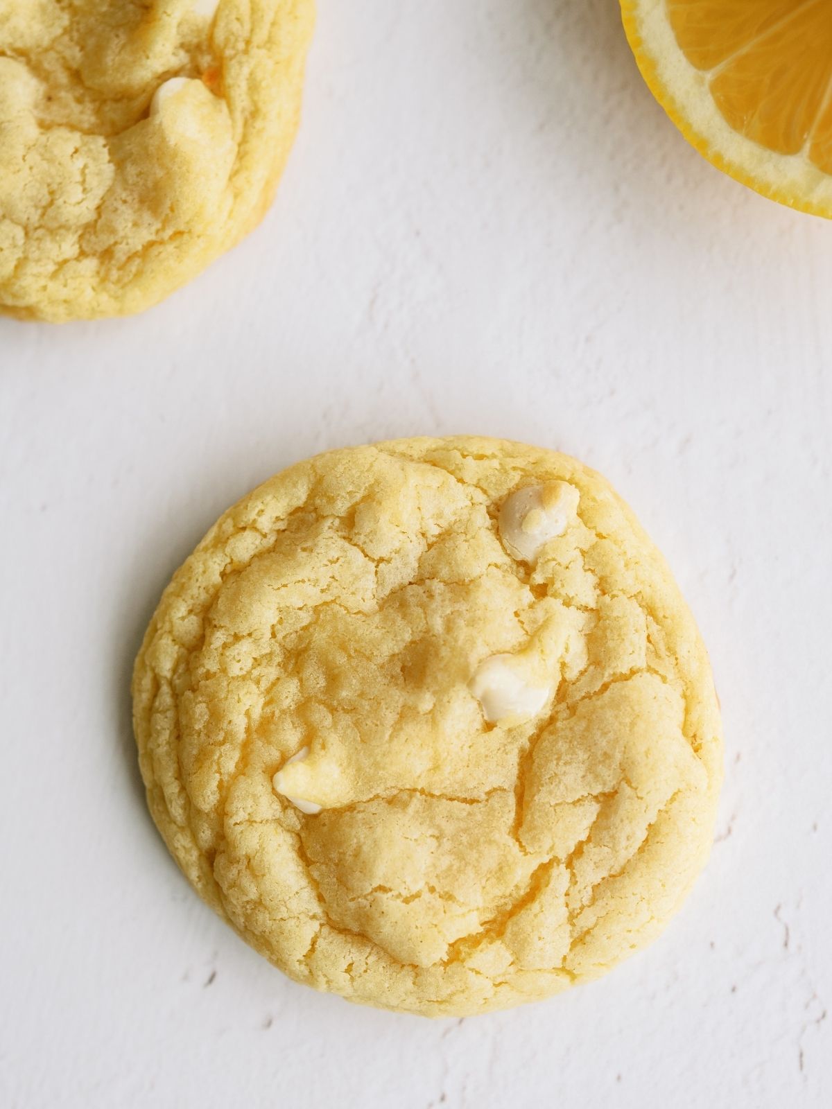 Lemon Cheesecake Pudding Cookie with lemons in the background