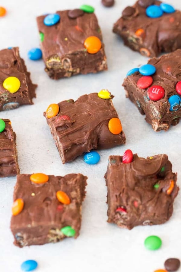 3 Ingredient M&M Fudge cut into squares. With mini m&m's surround the pieces.