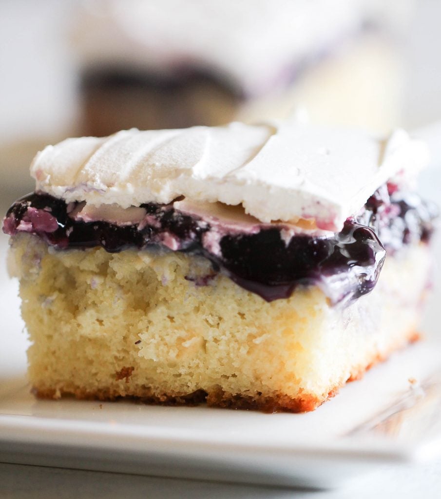 Slice of Blueberry Cheesecake Pudding Poke Cake on a plate