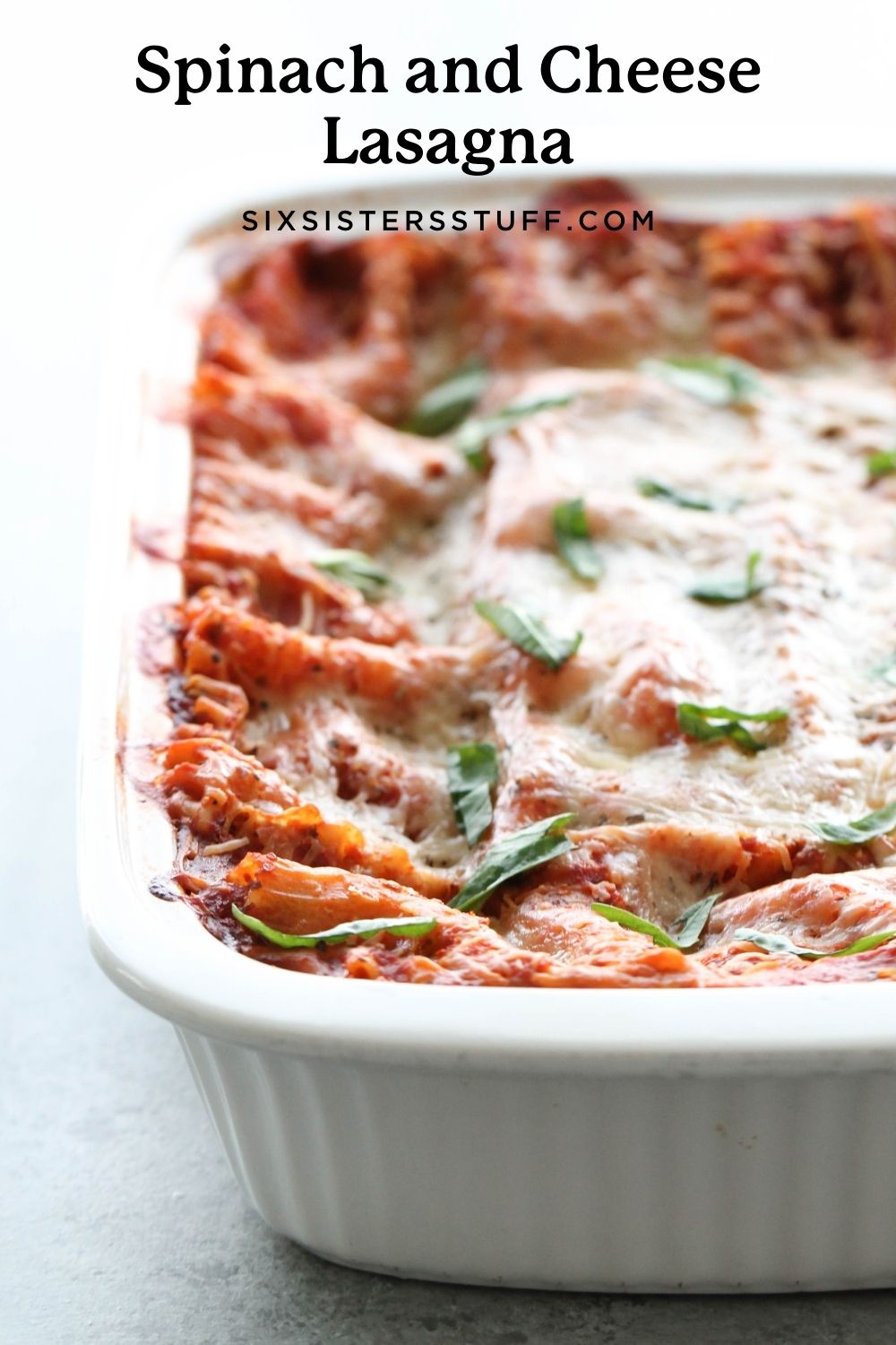 Spinach and cheese lasagna in pan for pinterest image