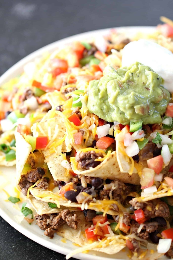 rainforest cafe loaded nachos on a plate with avocado
