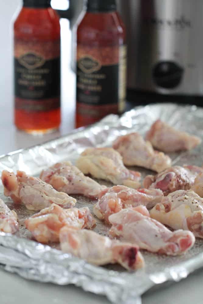 Raw chicken wings on a baking sheet