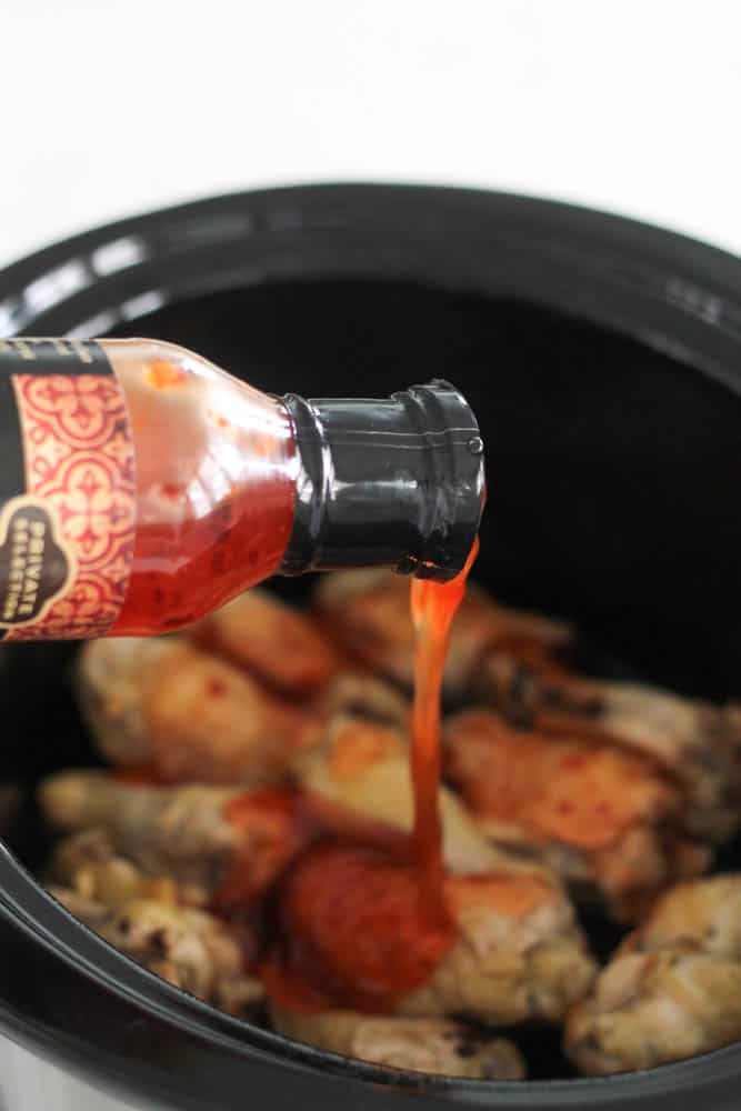 Wings in the slow cooker with sauce poured on them