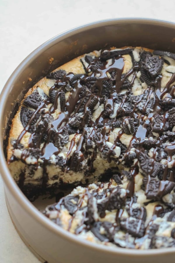 Cheesecake Factory Oreo Cheesecake in a springform pan with crushed oreos on top.