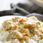 poppy seed chicken casserole served over rice on a plate