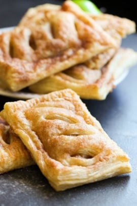 Stacked Apple Hand Pies on a black background.