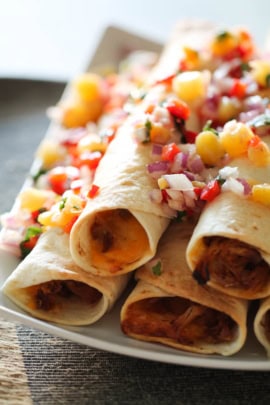 Hawaiian Pork Taquitos on a plate with fresh pineapple salsa